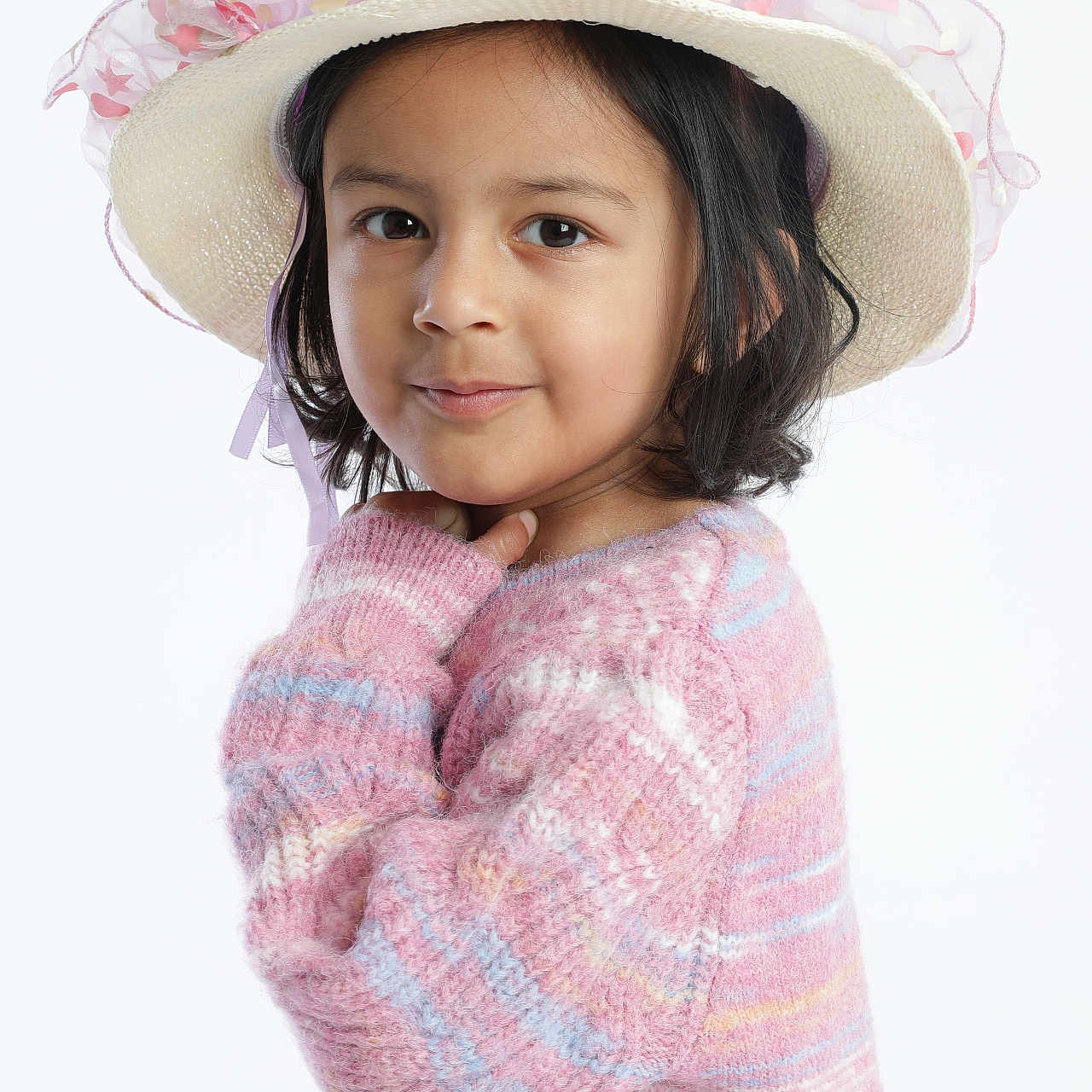 Aarvi Patel is registered to the contest to win money with this photo: child, childhood, cozy, cute, face, fashion, girl, hat, headwear, knitwear, long_sleeves, pastel_colors, person, pink, portrait, pose, smile, studio, sweater, young