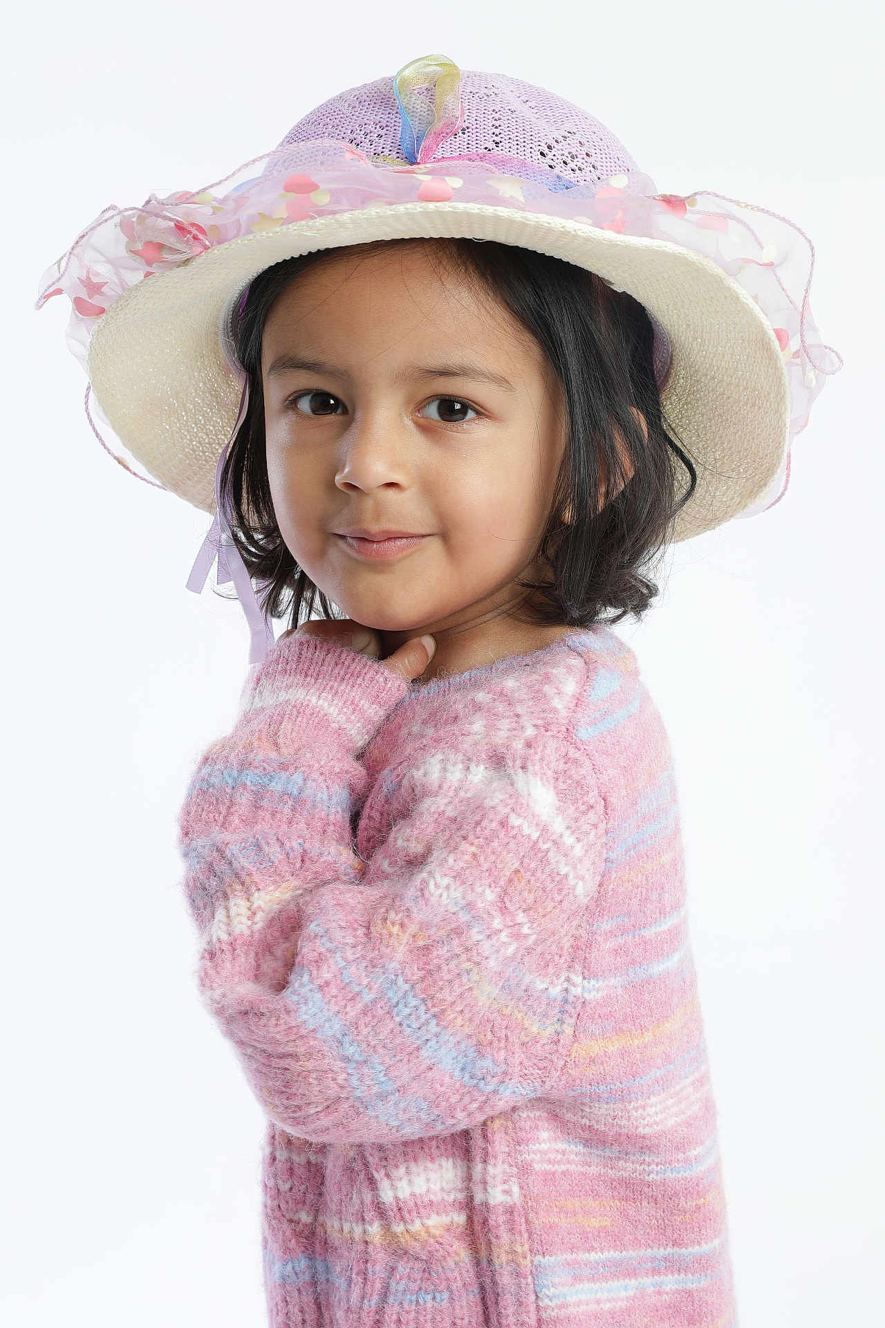 Aarvi Patel is registered to the contest to win money with this photo: child, girl, hat, sweater, pastel_colors, pink, portrait, cute, smile, face, long_sleeves, knitwear, fashion, young, studio, pose, headwear, cozy, childhood, person