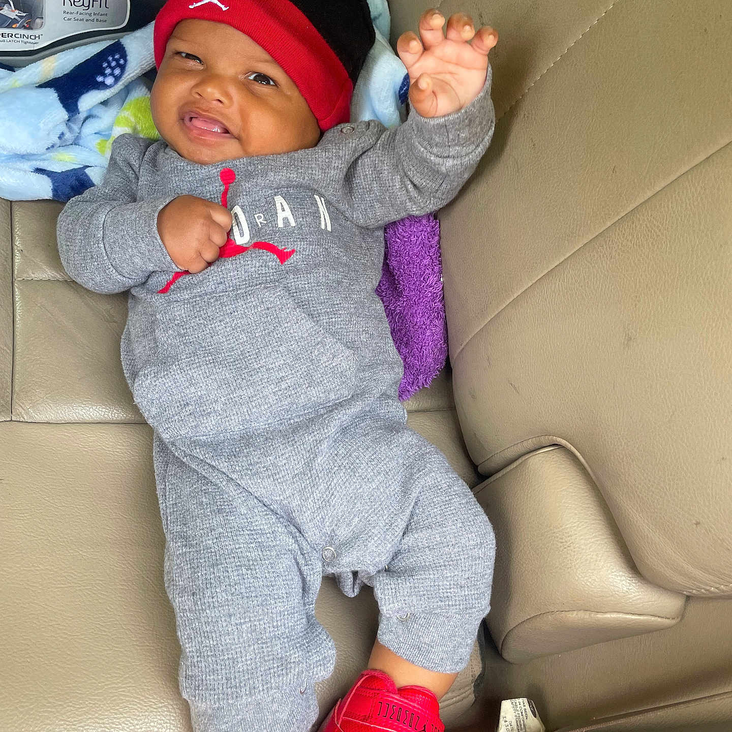 Bishop joined the competition — help win amazing prizes! baby, car_interior, car_seat, casual, child, clothing, cozy, cute, footwear, gray_outfit, happy, hat, indoor, infant, person, red_shoes, seat, smiling, waving, young
