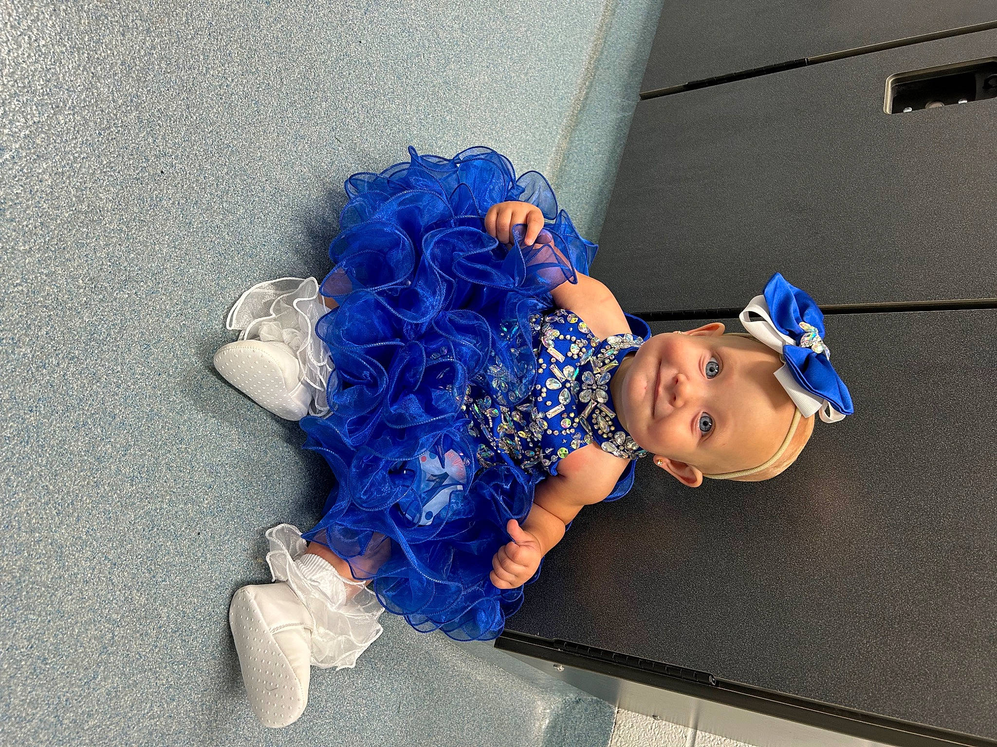 Penelope is registered to the contest to win money with this photo: azure, baby, baby_toddler_clothing, child, costume, denim, electric_blue, fashion_accessory, flooring, fun, hat, headgear, human_leg, joy, leisure, pattern, person, sitting, thigh, toddler