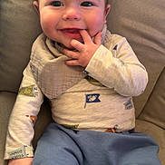 Jaxon joined the competition — help win amazing prizes! baby, child, smiling, sitting, indoor, clothing, bib, face, hand, couch, furniture, comfort, cute, infant, portrait, happy, young, cozy, casual, relaxed