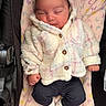 newborn, baby, sleeping, infant, child, portrait, stroller, blanket, coat, fluffy, pastel, butterfly_pattern, face, closed_eyes, hands, fists, clothing, socks, indoor, cuddly