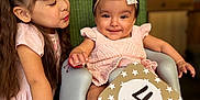 Luna is registered to the contest to win money with this photo: baby, child, infant, toddler, girl, smile, headband, pink_dress, baby_seat, wicker_chair, happy, cute, family, indoor, portrait, love, playing, sibling, celebration, milestone