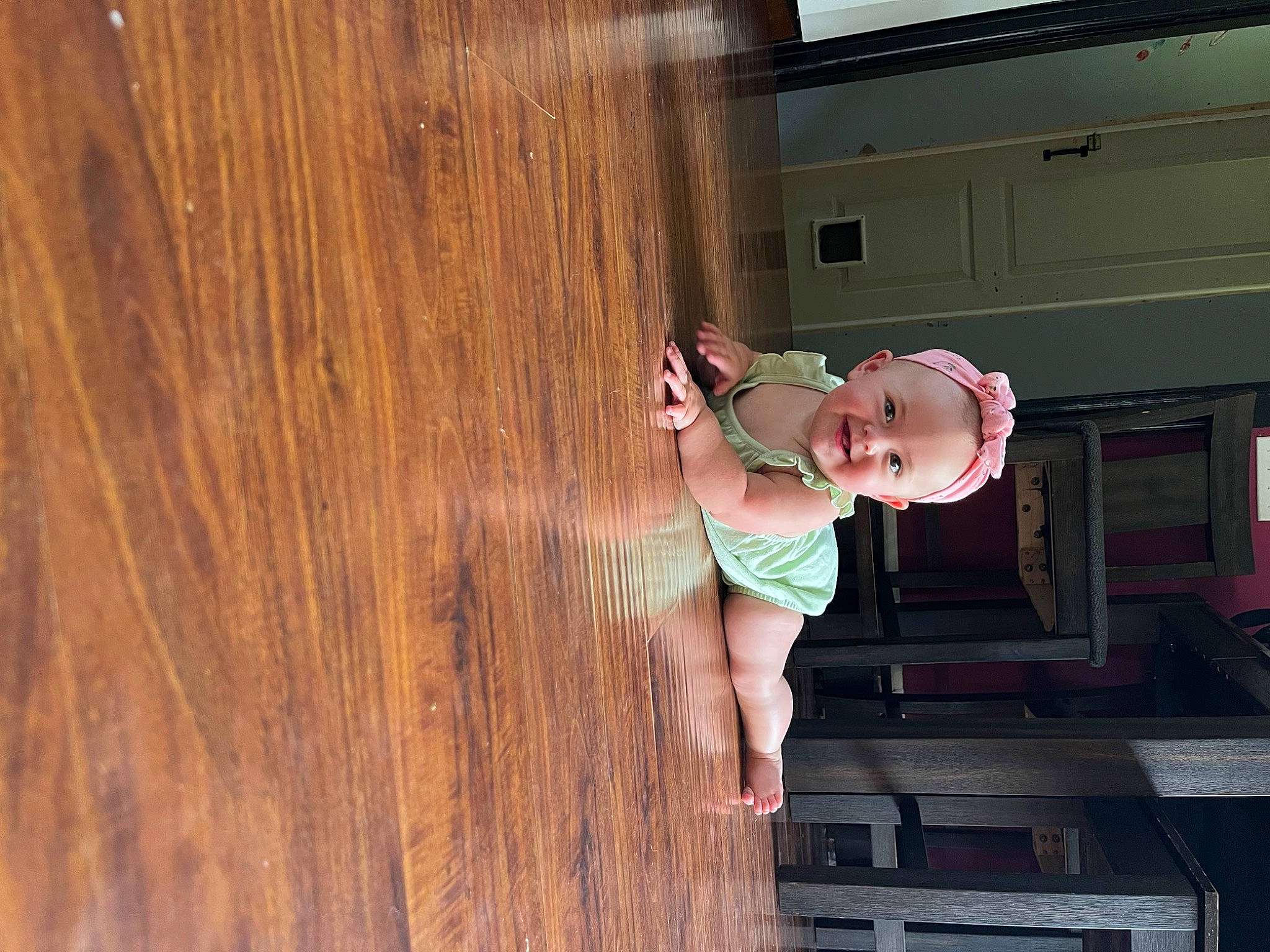 Madelynn is registered to the contest to win money with this photo: baby, ceiling, child, elbow, flooring, fun, hardwood, home_door, house, human_leg, joy, person, plank, plywood, room, smile, toddler, varnish, window, wood