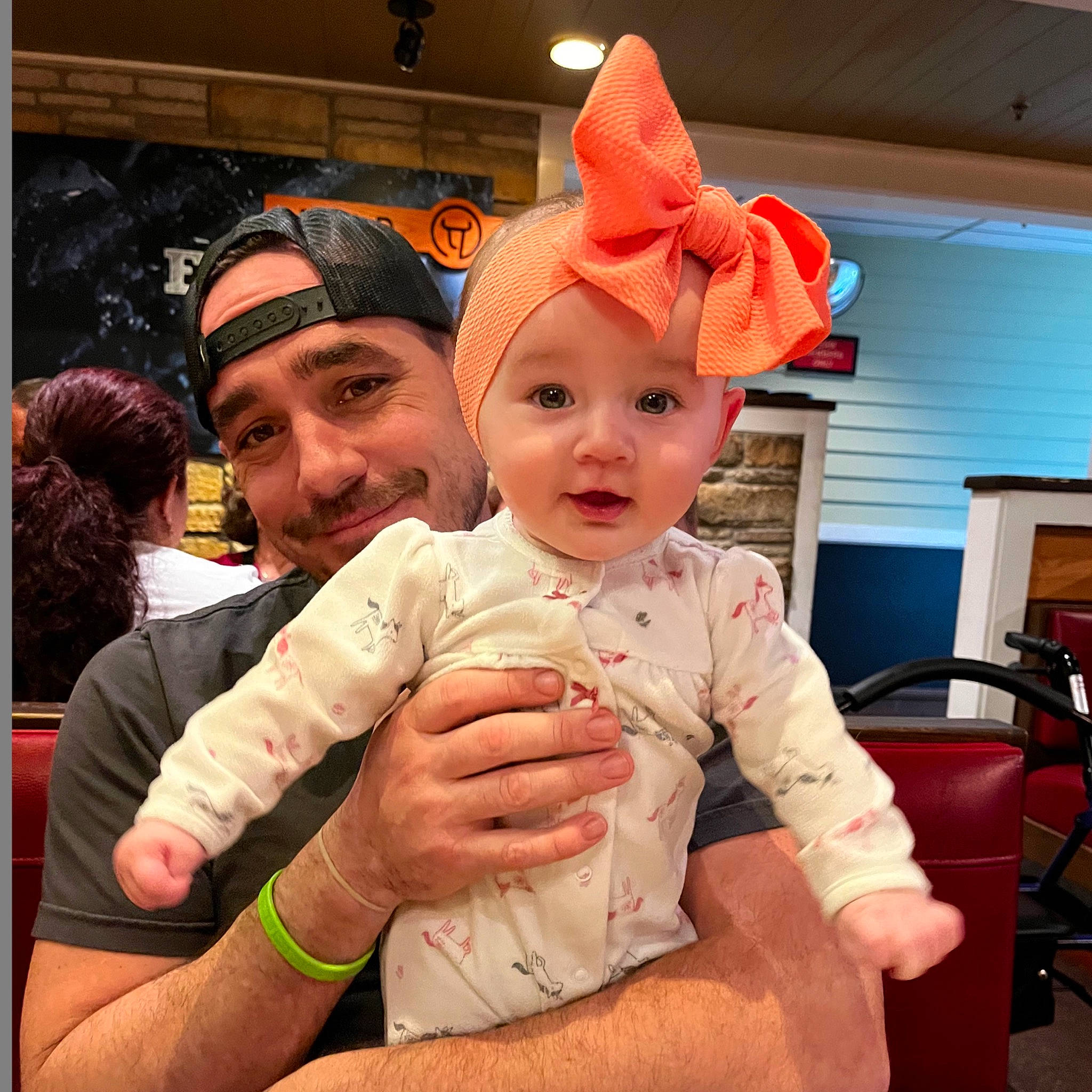 Stevie is registered to the contest to win money with this photo: baby, chair, child, christmas, christmas_eve, costume, costume_hat, event, fictional_character, fun, happy, hat, headwear, holiday, joy, lap, party_supply, person, room, smile