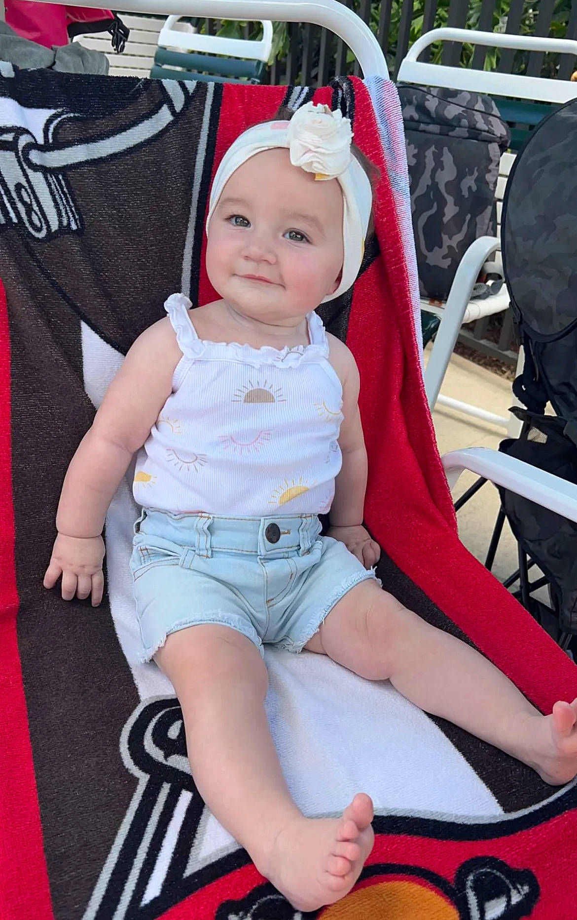 Stevie is registered to the contest to win money with this photo: baby, baby_carriage, baby_toddler_clothing, chair, cheek, child, comfort, hat, headwear, human_leg, joy, knee, lap, motor_vehicle, person, pink, shorts, sitting, skin, smile