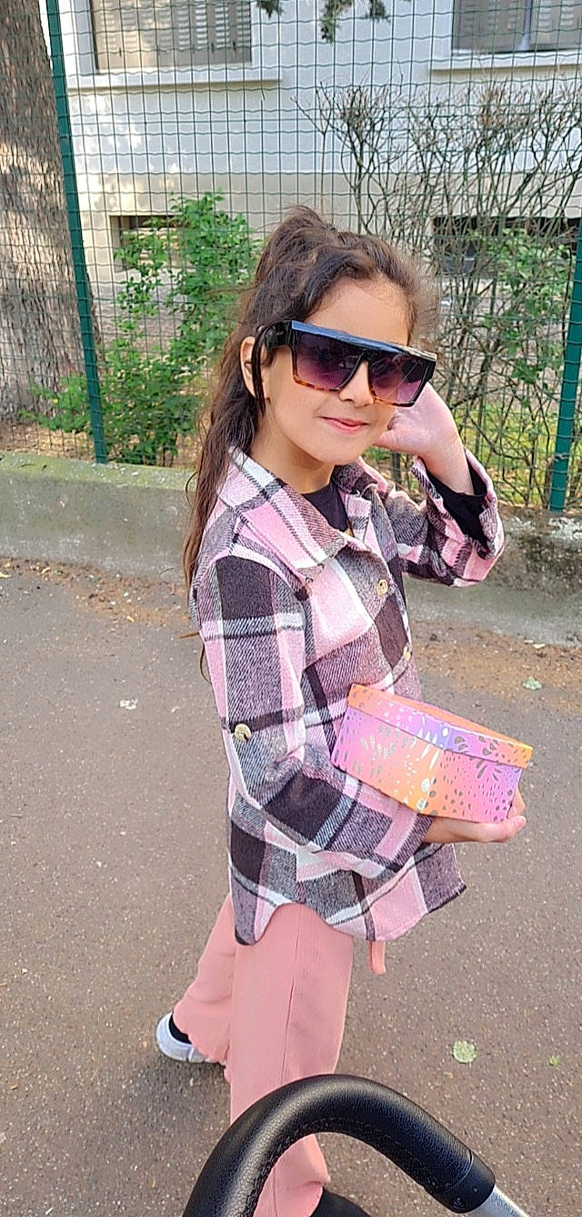 Maya participe au concours pour gagner de l'argent avec cette photo : clothing, denim, eyewear, fashion, joy, lip, neck, outerwear, person, plaid, plant, shoe, shoulder, sleeve, standing, street_fashion, sunglasses, t_shirt, tartan, textile