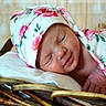 Kehlani joined the competition — help win amazing prizes! newborn, baby, sleeping, floral, blanket, hat, wicker_basket, pillow, peaceful, cute, infant, resting, soft, cozy, portrait, child, wrapped, closeup, indoors, relaxation
