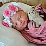 Kehlani is registered to the contest to win money with this photo: newborn, baby, infant, pink_blanket, floral_headband, teddy_bear, crocheted_toy, sleeping, pillow, wooden_bed, soft_lighting, cute, peaceful, indoors, portrait, child, wrapped, resting, tiny_hands, cozy