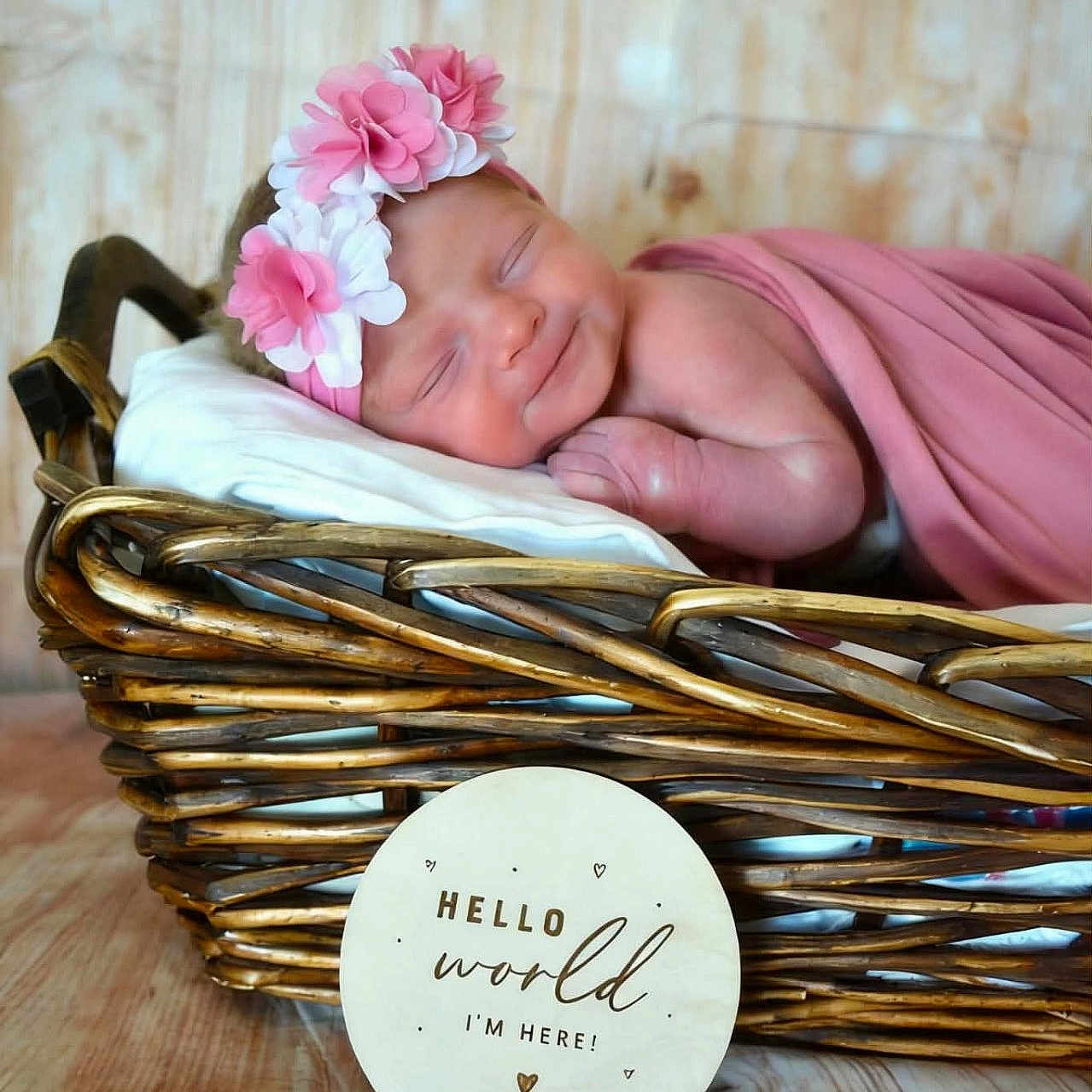 Kehlani joined the competition — help win amazing prizes! newborn, baby, sleeping, flower_headband, pink_blanket, basket, wooden_sign, announcement, soft_light, portrait, cute, peaceful, indoor, wood_floor, decor, infant, resting, headband, wrapped, child