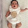 Elena is registered to the contest to win money with this photo: adorable, baby, bow, child, chubby_cheeks, crib, cute, four_months, headband, indoor, infant, love_text, lying_down, pacifier, patterned_sheet, portrait, soft_lighting, surprised_expression, white_dress, wooden_plaque