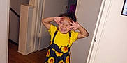 Kai'Lani Garnett is registered to the contest to win money with this photo: child, clothing, cute, door, feet, girl, hallway, hands, happy, home, indoor, joy, person, playful, posing, sandals, smiling, sunflower_dress, wooden_floor, yellow_shirt