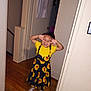 Kai'Lani Garnett is registered to the contest to win money with this photo: child, girl, yellow_shirt, sunflower_dress, sandals, wooden_floor, hallway, door, playful, smiling, happy, indoor, person, clothing, feet, hands, joy, home, cute, posing