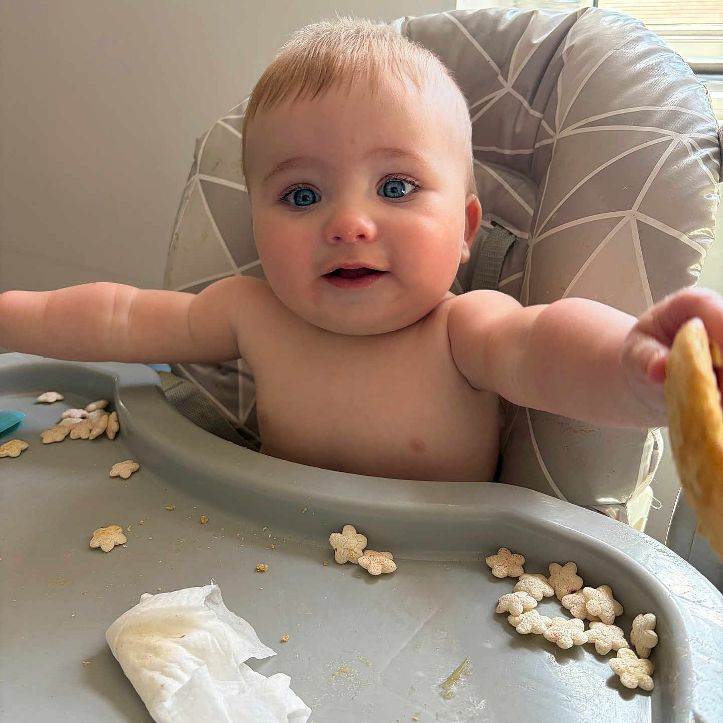 Romeo joined the competition — help win amazing prizes! baby, high_chair, cereal, blue_eyes, face, arm, window, tissue, food, infant, child, indoor, plastic_tray, cute, expression, skin, reaching, messy, seat, natural_light