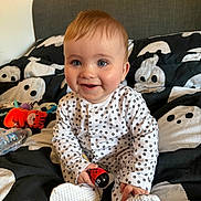 Romeo joined the competition — help win amazing prizes! baby, bed, bedspread, child, cozy, cute, face, ghost_pattern, happy, head, indoors, ladybug, onesie, person, plush_toy, polka_dot, sitting, smile, toy, water_bottle