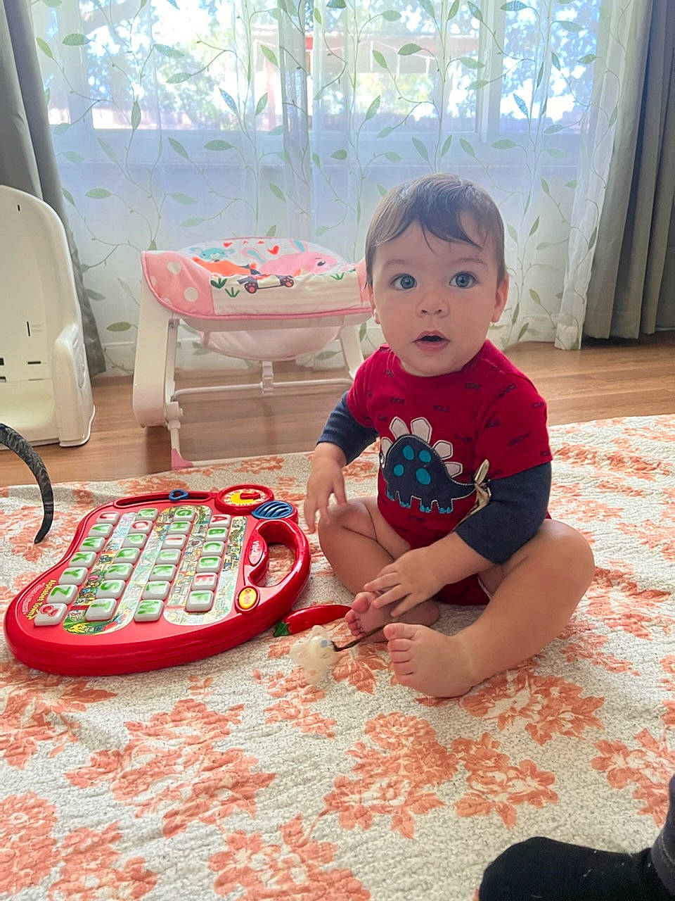 Jensen joined the competition — help win amazing prizes! baby, baby_toddler_clothing, carmine, child, comfort, floor, flooring, fun, hairstyle, head, mammal, pattern, person, play, red, sitting, sleeve, standing, surprise, toddler