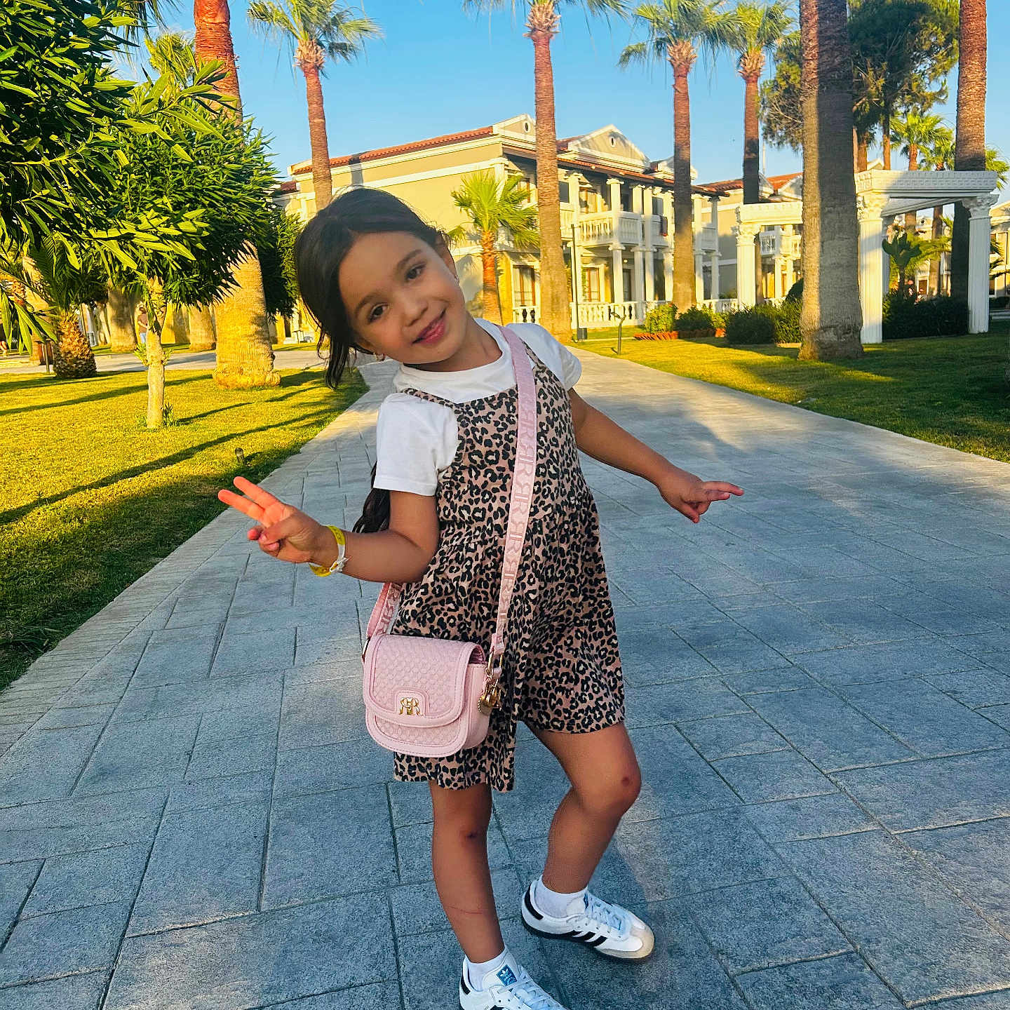 Eva joined the competition — help win amazing prizes! building, child, dress, fashion, girl, greenery, happy, leopard_print, outdoor, palm_trees, peace_sign, pink_purse, playful, pose, sidewalk, smiling, sneakers, summer, sunny, white_tshirt