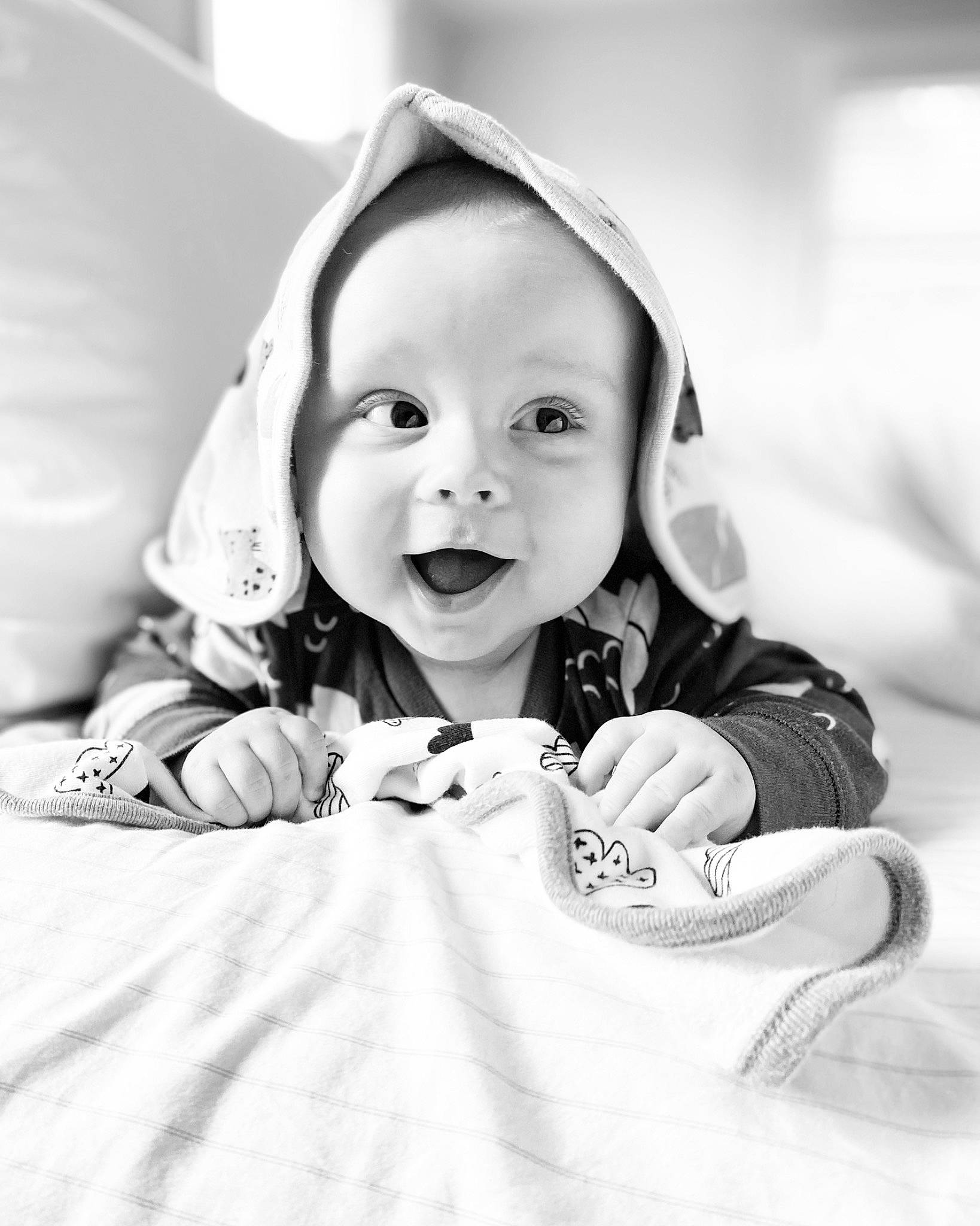 Theodore is registered to the contest to win money with this photo: art, baby, baby_toddler_clothing, black_and_white, child, comfort, facial_expression, flash_photography, fun, happy, linens, monochrome, monochrome_photography, person, sitting, sleeve, smile, stock_photography, style, textile