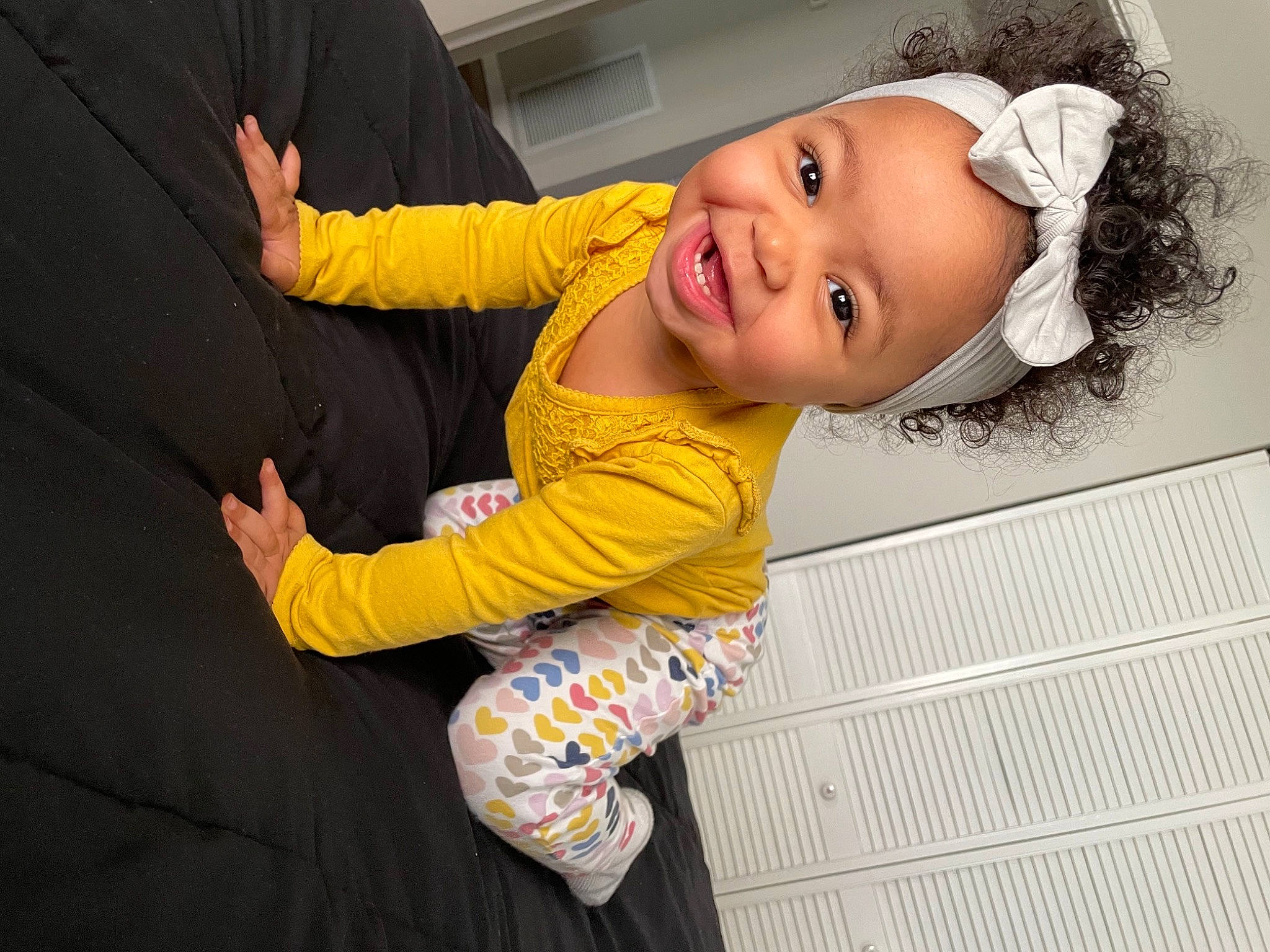 Avaya is registered to the contest to win money with this photo: baby, baby_laughing, baby_products, baby_toddler_clothing, cheek, child, comfort, flash_photography, flooring, fun, gesture, happy, magenta, person, portrait_photography, sitting, skin, sleeve, smile, thumb
