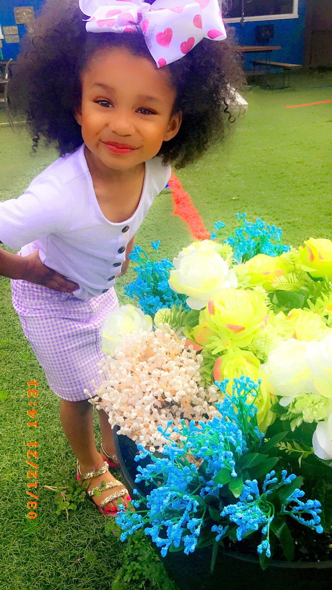 Riley-rose is registered to the contest to win money with this photo: baby_toddler_clothing, blue, child, flower, flower_arranging, fun, grass, green, happy, joy, nature, people_in_nature, person, petal, photograph, pink, plant, smile, summer, toddler