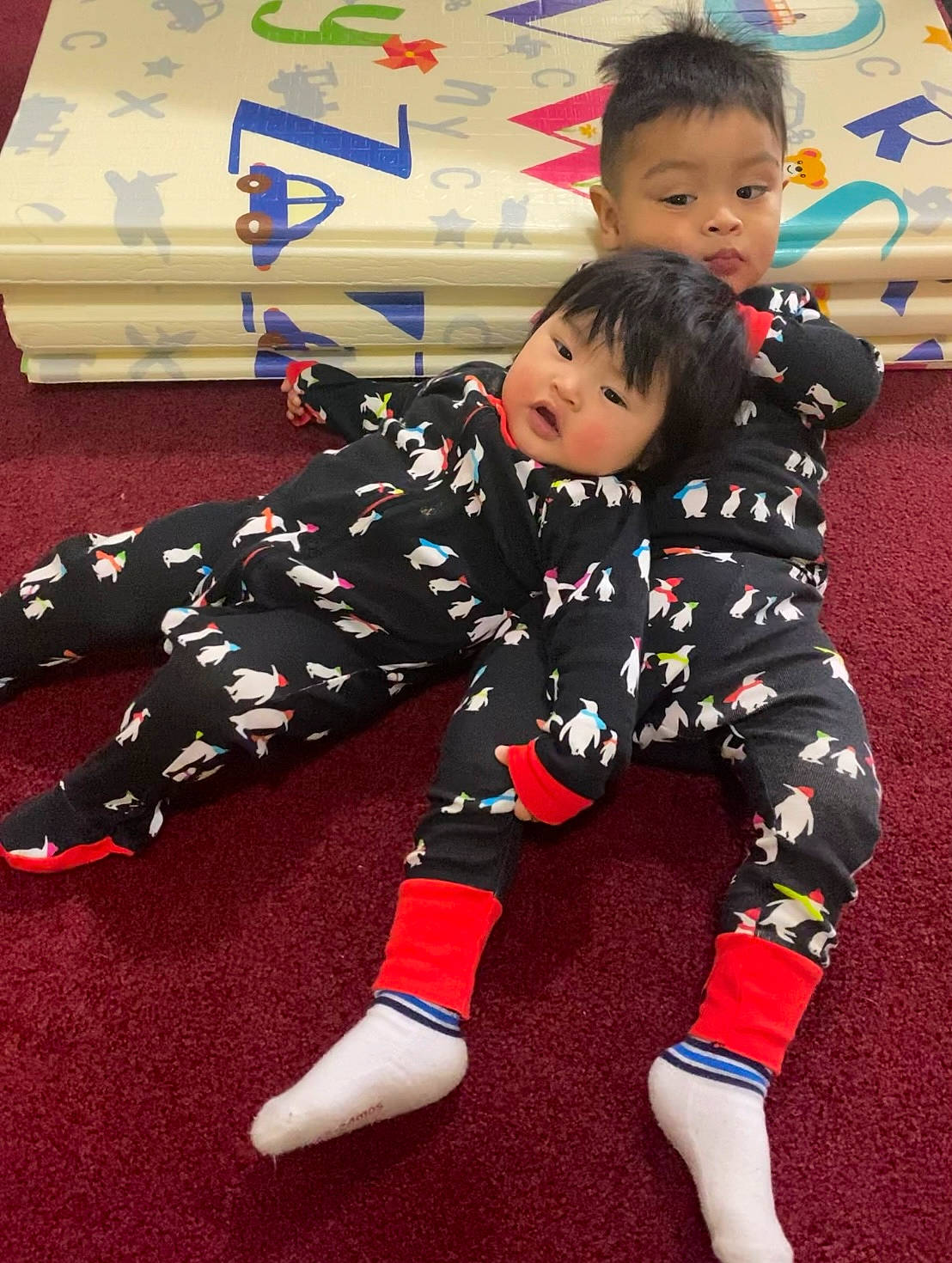 Cj is registered to the contest to win money with this photo: baby_toddler_clothing, carmine, carpet, child, comfort, face, floor, flooring, fun, happy, head, holiday, lap, leg, pattern, person, sitting, sleeve, smile, sock