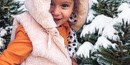 Kaila a rejoint le concours — aidez-le/la à gagner de superbes lots ! child, cold_weather, cute, forest, fur, happy, hood, nature, orange_clothing, outdoors, person, pine_trees, playful, portrait, seasonal, smiling, snow, warm_clothing, winter, young_child