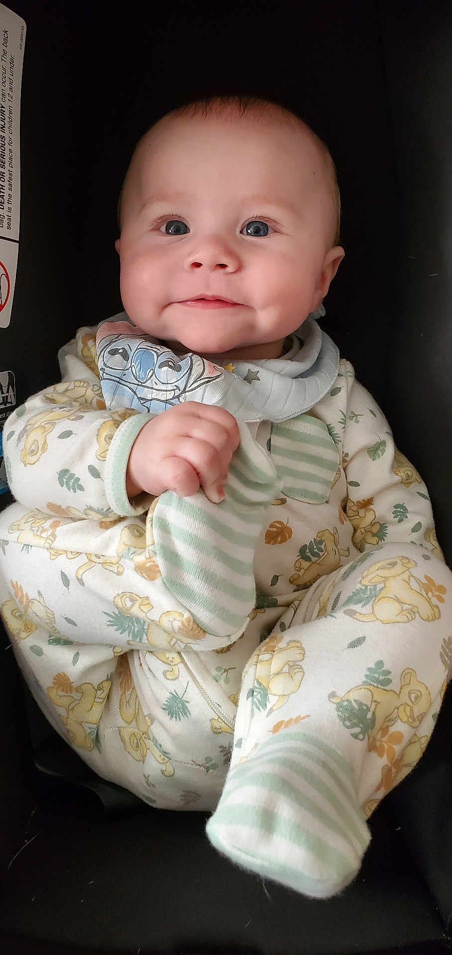 Jaxton joined the competition — help win amazing prizes! baby, infant, smiling, car_seat, onesie, striped_sock, bib, blue_eyes, chubby_cheeks, hand, portrait, closeup, cute, dimple, fabric_pattern, lion_print, soft_lighting, seat_label, sitting, clutching