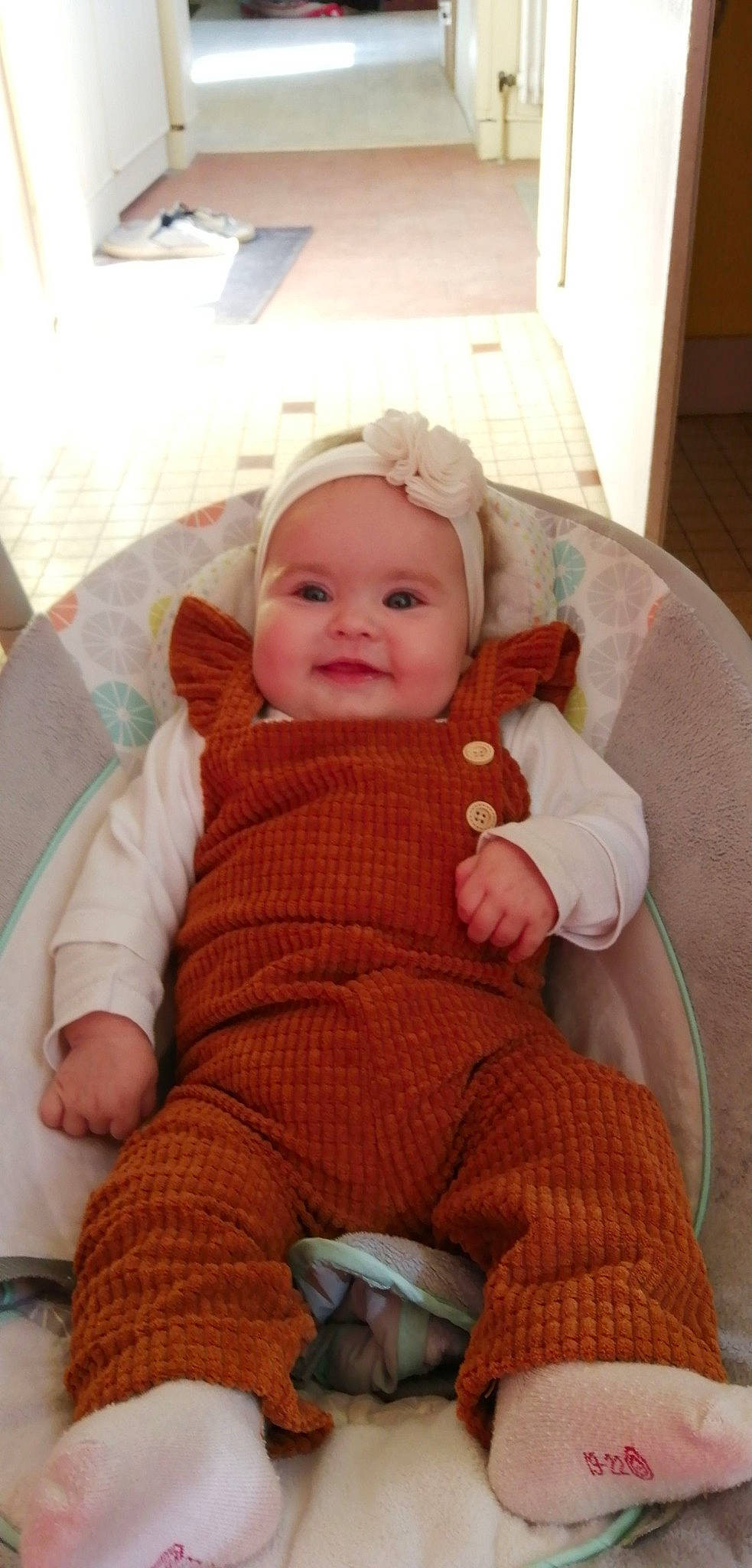 Celia participe au concours pour gagner de l'argent avec cette photo : baby, baby_products, baby_toddler_clothing, carmine, cheek, child, comfort, fur, headwear, joy, lap, pattern, person, pink, room, sitting, skin, sleeve, smile, sock