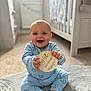 baby, infant, smiling, blue_onesie, wooden_plaque, eight_months, rug, nursery, crib, carpet, happy, child, indoor, cute, sitting, person, home, soft_lighting, portrait, teeth
