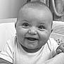 baby, smiling, infant, face, portrait, closeup, black_and_white, happy, cute, child, person, clothing, couch, hand, indoors, young, expression, sitting, skin, head
