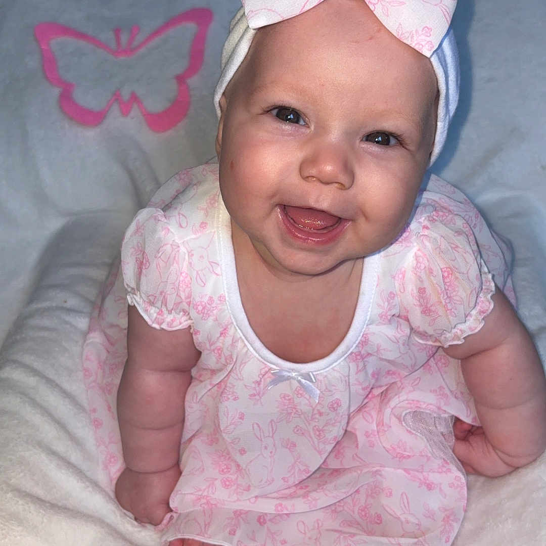 Lylah joined the competition — help win amazing prizes! baby, blanket, bow, butterfly, child, chubby_cheeks, cute, flash, floral_pattern, happy, headband, indoor, infant, open_mouth, pink_dress, plush, portrait, sitting, smiling, tooth