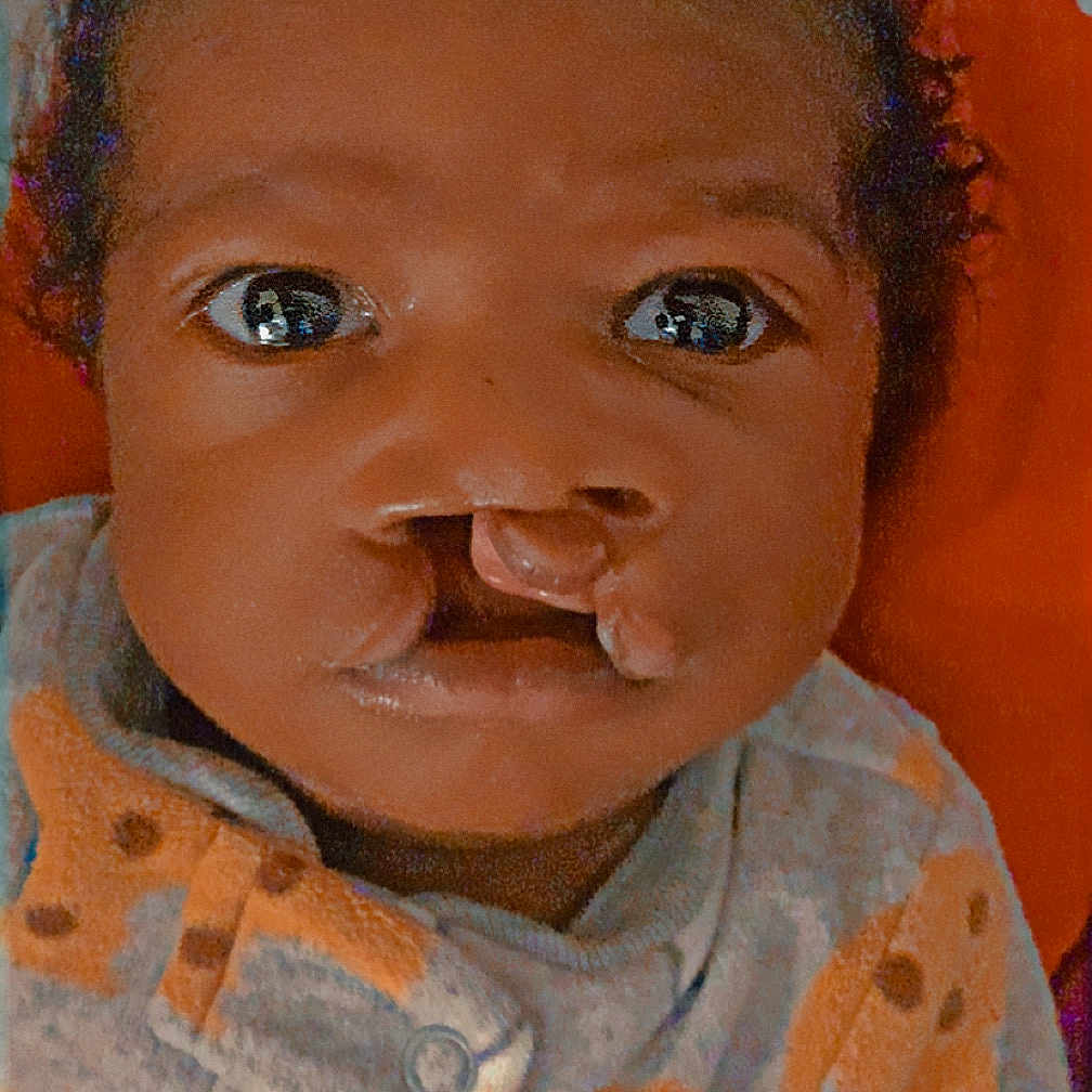 Denali is registered to the contest to win money with this photo: baby, bodypart, bonnet, cap, clothing, doll, face, frown, happy, hat, head, knitwear, mouth, person, photography, portrait, sad, smile, sweater, toy