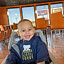 Noah joined the competition — help win amazing prizes! toddler, child, smile, high_chair, jacket, shirt, bear_graphic, restaurant, table, chair, window, orange_wall, floor_tiles, indoor, lighting, happy, person, baby, casual_clothing, cute