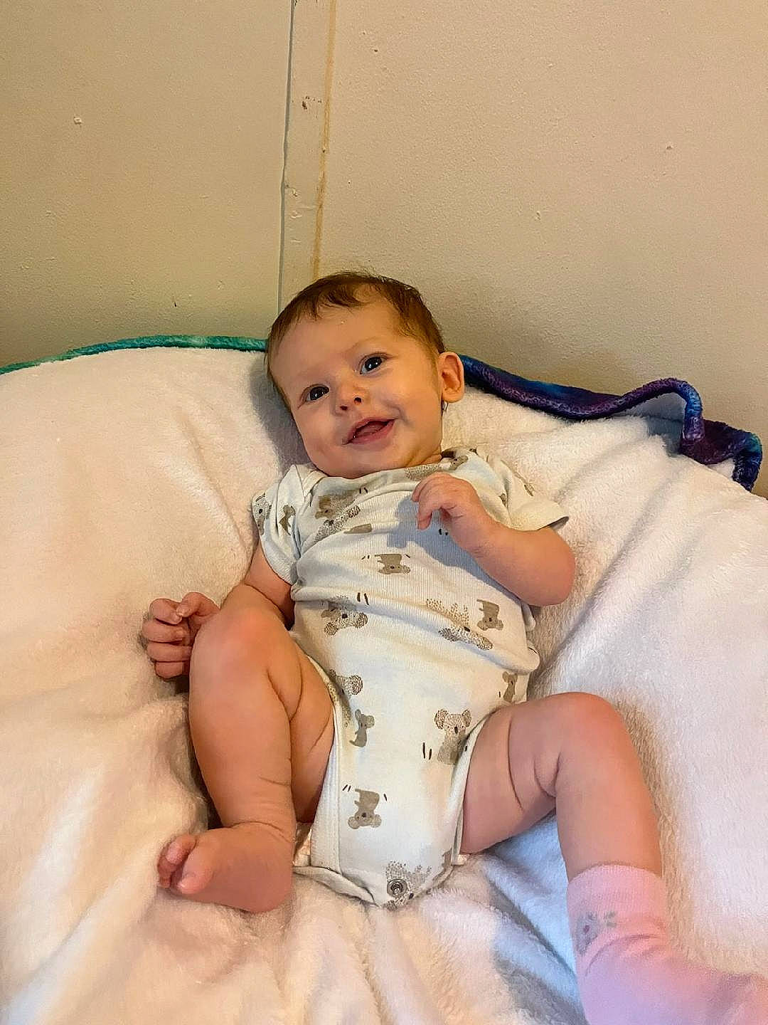 Cassandra is registered to the contest to win money with this photo: abdomen, arm, baby, baby_toddler_clothing, chest, child, comfort, elbow, finger, happy, human_body, human_leg, joy, linens, person, sitting, skin, smile, stomach, thigh