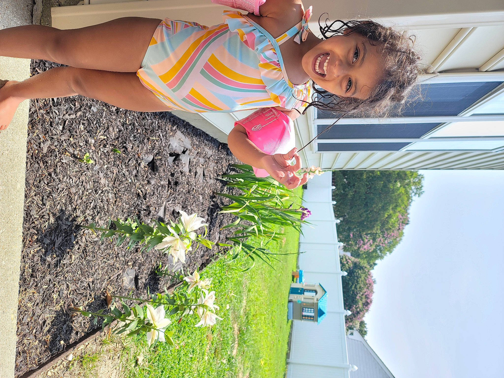 Lilly is registered to the contest to win money with this photo: flower, fun, grass, green, happy, human_leg, joy, leisure, light, people_in_nature, person, photograph, plant, shorts, shrub, sky, smile, snapshot, summer, thigh