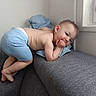 Kaïssy participe au concours pour gagner de l'argent avec cette photo : toddler, child, blue_shorts, couch, pillow, window, indoor, skin, bareback, hand, face, earring, curly_hair, resting, smiling, playful, light, cozy, corner, home
