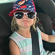 Maëlys a rejoint le concours — aidez-le/la à gagner de superbes lots ! child, car_seat, seatbelt, sunglasses, cap, cartoon, attitude, pout, blonde_hair, striped_shirt, casual_clothing, car_interior, window, daylight, young, portrait, person, cute, summer, travel