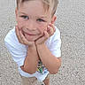 Gennaro participe au concours pour gagner de l'argent avec cette photo : child, boy, smiling, standing, outdoor, shorts, tshirt, sandals, batman_logo, hands_on_face, playful, happy, casual_clothing, short_hair, looking_up, gravel, summer, cute, person, feet