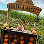 Ophelia joined the competition — help win amazing prizes! baby, pumpkin, pumpkin_market, farm, cornfield, fall, autumn, outdoor, smiling, wooden_sign, gourds, plants, leaves, greenery, nature, child, headband, clothing, rustic, sky