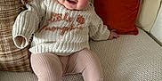 Ophelia is registered to the contest to win money with this photo: baby, child, smiling, sitting, couch, pillow, headband, bow, sweater, leggings, sock, indoor, cozy, happy, person, portrait, cute, infant, homedecor, soft