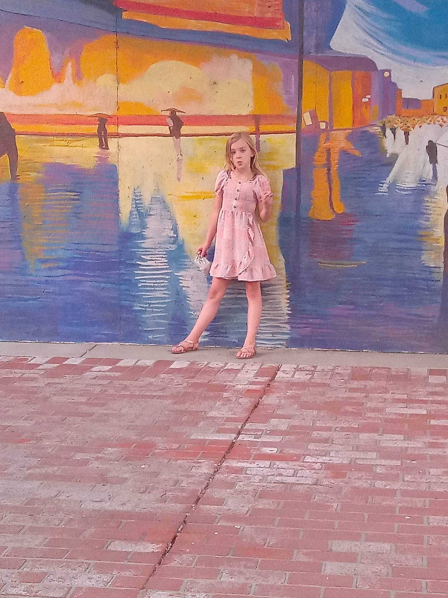 Alexandra is registered to the contest to win money with this photo: art, body_of_water, city, drawing, evening, flooring, fun, illustration, leisure, magenta, mural, paint, painting, person, reflection, road_surface, sky, tints_and_shades, visual_arts, water