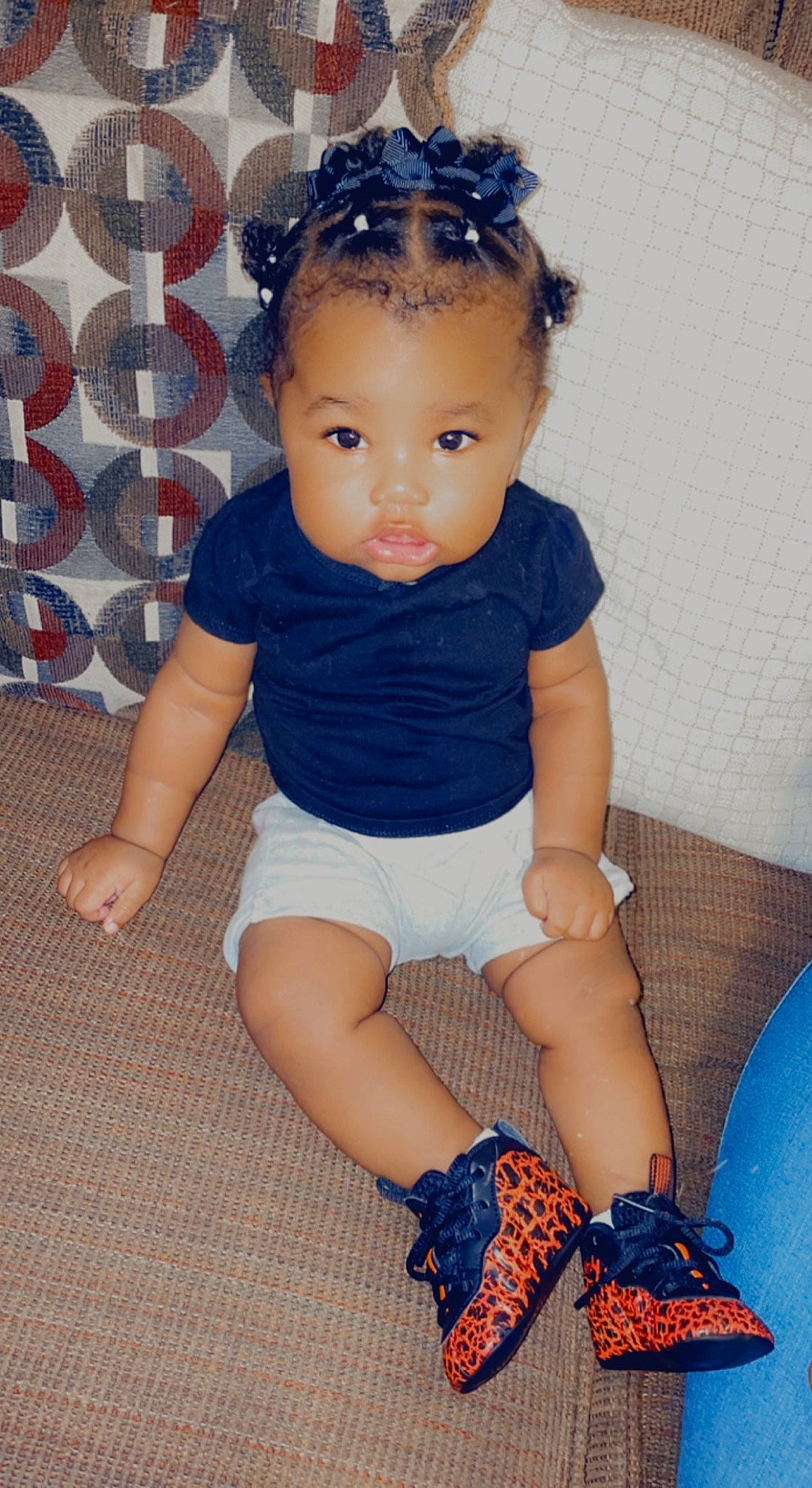 Niyelle is registered to the contest to win money with this photo: arm, baby_toddler_clothing, blue, cheek, child, electric_blue, fashion_accessory, foot, headpiece, human_leg, knee, pattern, person, shorts, sitting, sleeve, sock, textile, thigh, toddler