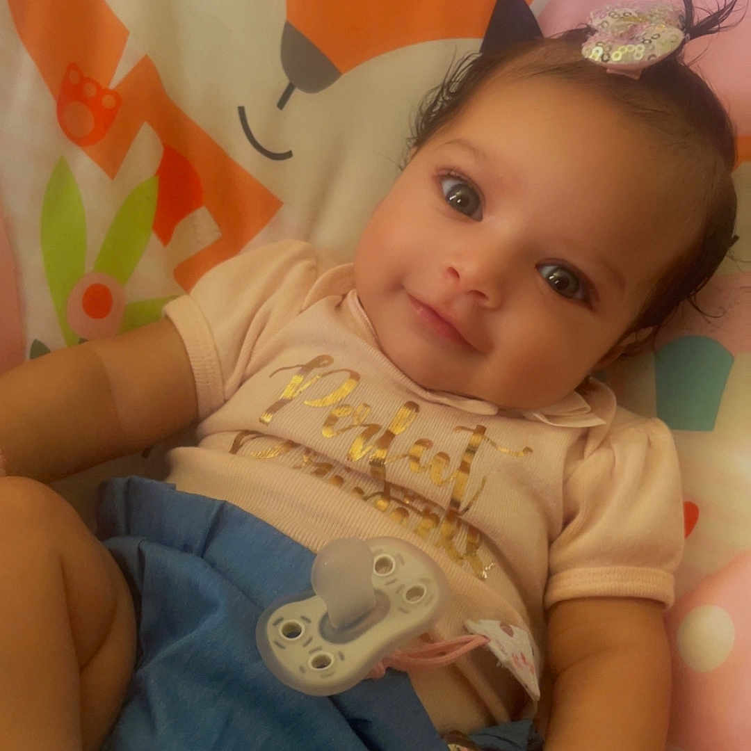 Zaila joined the competition — help win amazing prizes! accessories, baby, bodypart, bracelet, clothing, couch, cushion, face, finger, furniture, hand, head, homedecor, jewelry, newborn, person, photography, portrait, sitting, t_shirt