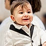 baby, child, toddler, smiling, portrait, face, eyes, hair, white_jacket, black_trim, button, cheeks, happy, formal_wear, suit, closeup, indoor, person, adorable, grin