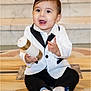 Dylan is registered to the contest to win money with this photo: baby, toddler, child, sitting, tuxedo, white_jacket, black_pants, socks, candle, marble_floor, stairs, smiling, happy, portrait, indoor, one_person, close_up, formal_attire, cute, chubby_cheeks