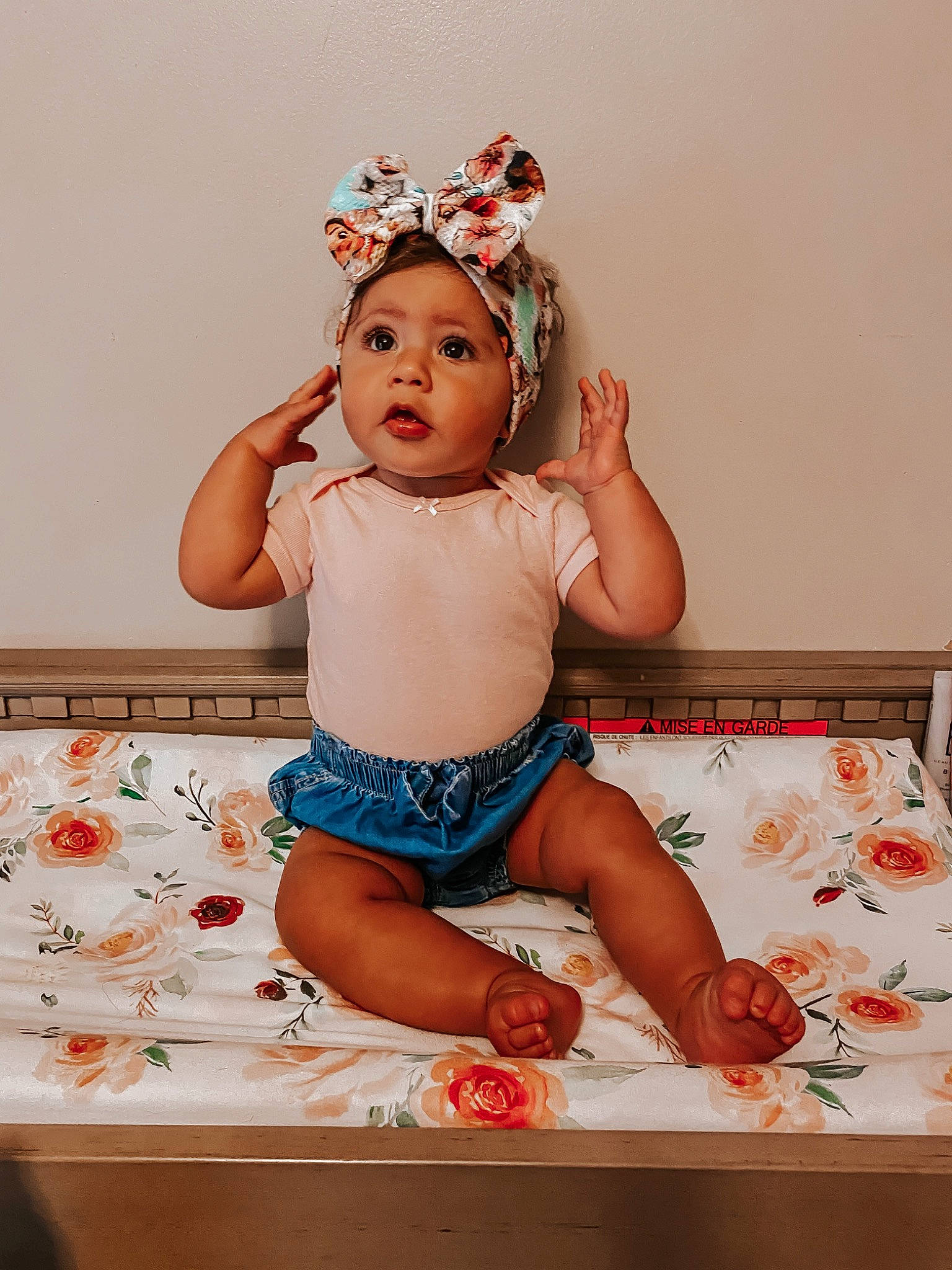 Ziah is registered to the contest to win money with this photo: baby, baby_bloomers, baby_toddler_clothing, cheek, child, fashion_accessory, hair_accessory, headband, headgear, headpiece, headwear, leg, person, sitting, surprise, toddler