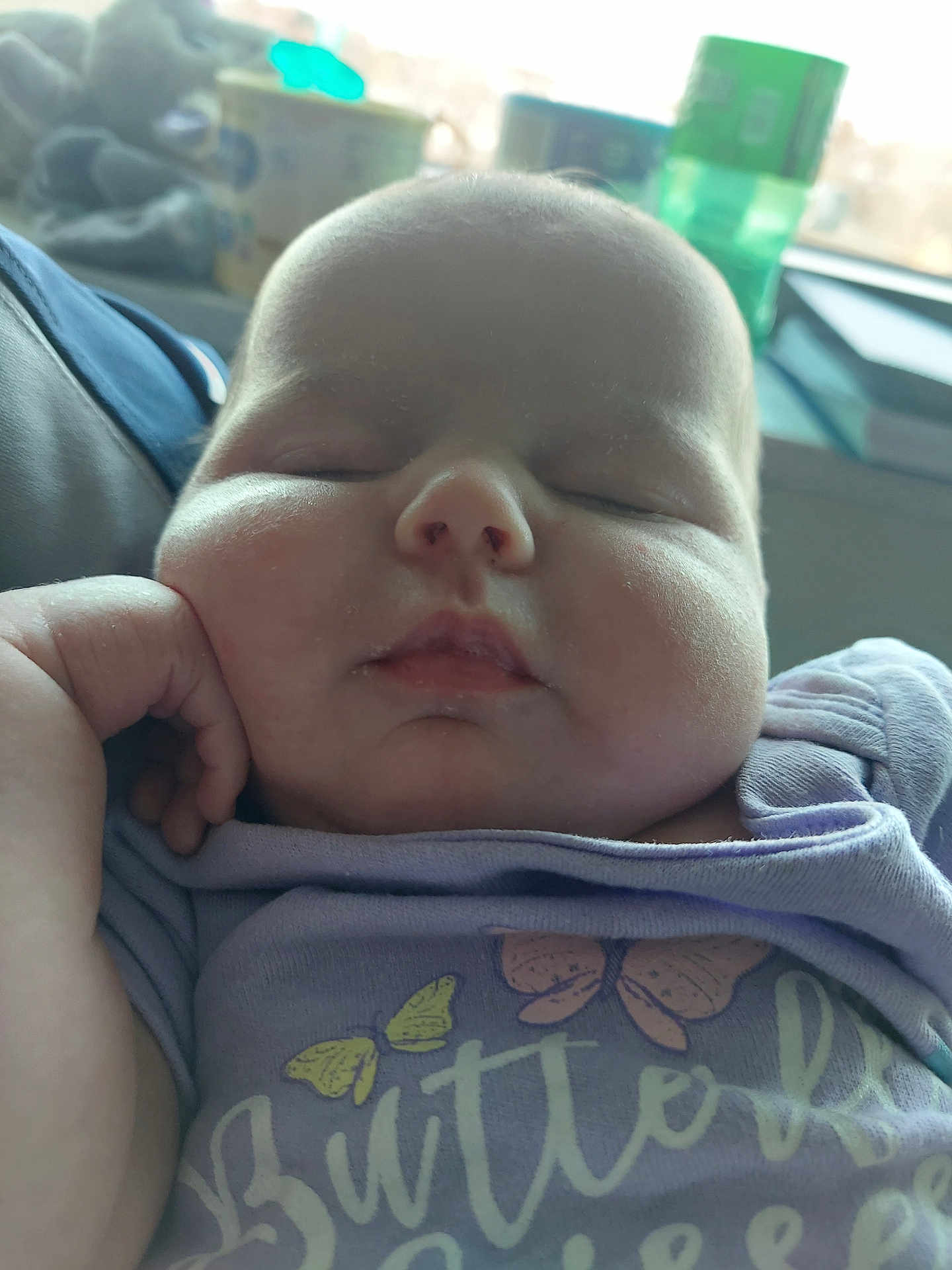 Sofia is registered to the contest to win money with this photo: baby, sleeping, face, hand, purple_shirt, butterfly, chubby_cheeks, infant, closeup, peaceful, cute, child, young, portrait, relaxed, indoors, soft_light, person, apparel, resting
