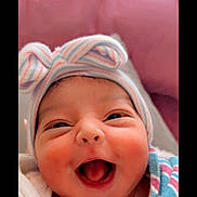 Irha joined the competition — help win amazing prizes! baby, infant, smiling, happy, face, hat, bow, blanket, cheeks, closeup, cute, joyful, newborn, portrait, wrapped, clothing, child, cozy, pink_background, expression