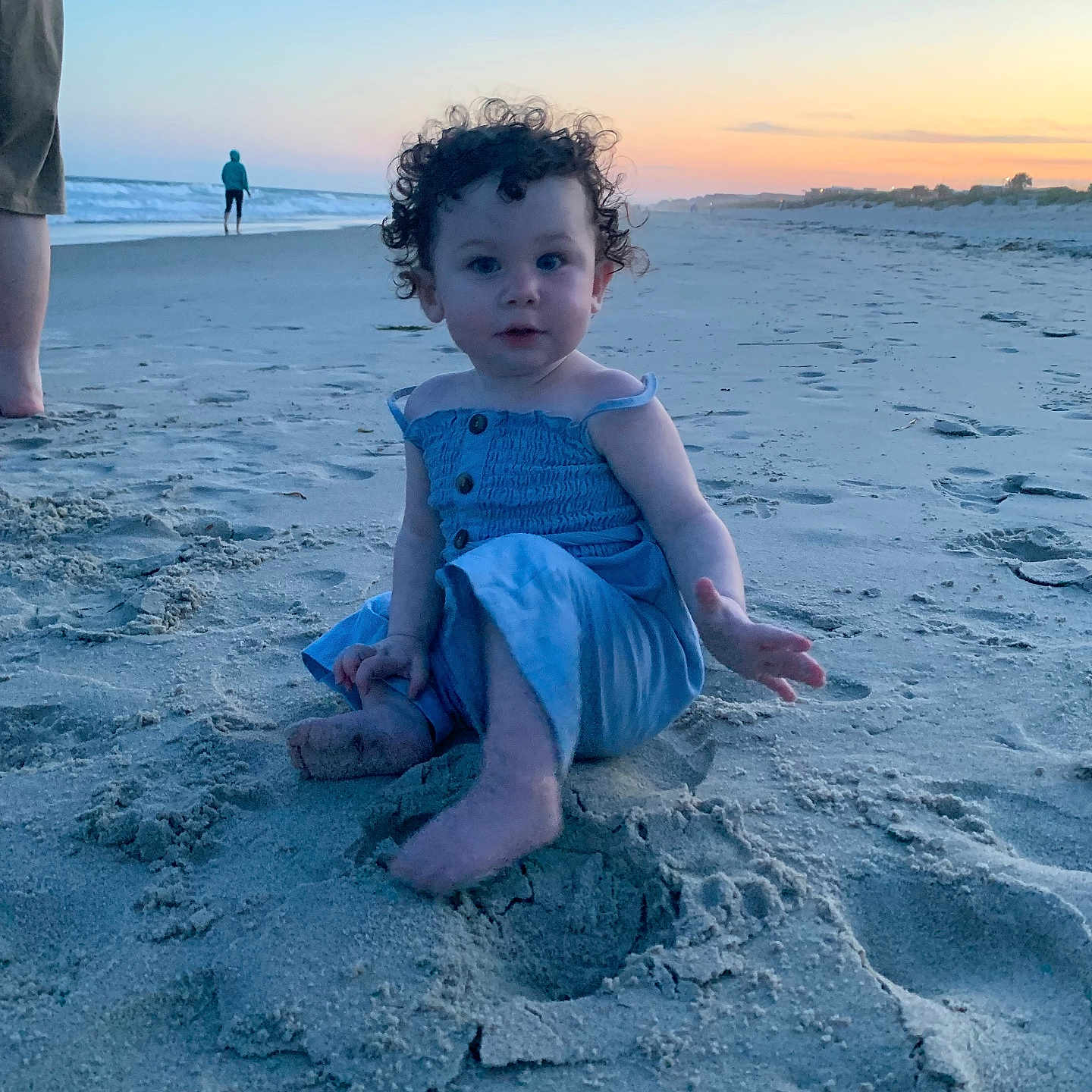 Pamela is registered to the contest to win money with this photo: baby, beach, beachwear, clothing, coast, face, hair, head, horizon, nature, outdoors, person, photography, portrait, sea, shoreline, shorts, sitting, sky, water