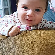 Emmanual joined the competition — help win amazing prizes! baby, child, face, smile, sweater, hand, indoor, person, curly_hair, cute, portrait, young_child, closeup, cozy, expression, looking_at_camera, skin, furniture, texture, warm_light